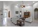 Spacious living room with tile floors, high ceilings, white sofas and an entertainment center at 4239 Fawn Meadows Cir, Clermont, FL 34711
