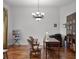 Bright office features hardwood floors, large window, elegant chandelier, and a spacious desk with seating at 4239 Fawn Meadows Cir, Clermont, FL 34711