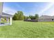 Large grassy backyard area with partial view of covered patio; great for pets and entertaining at 472 Malauka Radl, Ocklawaha, FL 32179