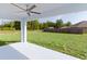 View of the newly cut backyard with a fenced perimeter as seen from the covered back patio at 472 Malauka Radl, Ocklawaha, FL 32179