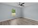 This bedroom has a large window and hardwood floors at 472 Malauka Radl, Ocklawaha, FL 32179