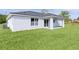 The home boasts a manicured lawn and a covered patio for outdoor enjoyment at 472 Malauka Radl, Ocklawaha, FL 32179