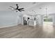Open concept view of the kitchen with a kitchen island, stainless appliances, and wood grain flooring at 472 Malauka Radl, Ocklawaha, FL 32179
