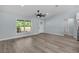 A spacious living room features a window with a nature view and wood grain floors at 472 Malauka Radl, Ocklawaha, FL 32179