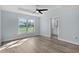 Main Bedroom with modern ceiling fan, wood grain floors and window with backyard views at 472 Malauka Radl, Ocklawaha, FL 32179