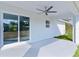Covered patio with a ceiling fan, sliding glass doors, and access to the spacious, well-maintained backyard at 472 Malauka Radl, Ocklawaha, FL 32179