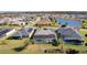 Aerial view of the community with ponds and single-Gathering homes featuring backyard pools and screened patios at 4878 Chitty Chatty Run, The Villages, FL 32163
