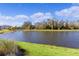 Picturesque backyard featuring a large pond and lush landscaping at 4878 Chitty Chatty Run, The Villages, FL 32163