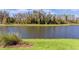 Scenic backyard featuring a tranquil pond and lush green grass at 4878 Chitty Chatty Run, The Villages, FL 32163