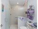 Modern bathroom featuring a glass shower, granite countertop, and decorative accents at 4878 Chitty Chatty Run, The Villages, FL 32163