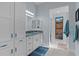 Bright bathroom with white cabinets, granite countertops, and blue accents at 4878 Chitty Chatty Run, The Villages, FL 32163