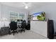 Bright bedroom featuring a murphy bed, desk area, and large window at 4878 Chitty Chatty Run, The Villages, FL 32163