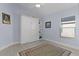 Bright bedroom with a Murphy bed, adjacent shelving, and a large decorative rug at 4878 Chitty Chatty Run, The Villages, FL 32163