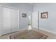 Bedroom features closet, light colored floors, and blue walls at 4878 Chitty Chatty Run, The Villages, FL 32163