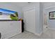 Bedroom featuring a television displaying a home's exterior and a storage closet at 4878 Chitty Chatty Run, The Villages, FL 32163
