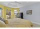 Bedroom featuring a decorative bay window, yellow bedspread, and a black dresser at 4878 Chitty Chatty Run, The Villages, FL 32163