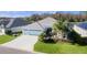 Charming single-story home with a well-manicured lawn, tropical landscaping, and a three-car garage at 4878 Chitty Chatty Run, The Villages, FL 32163