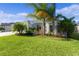 Well-maintained lawn and lush landscaping accentuate this inviting light-blue home at 4878 Chitty Chatty Run, The Villages, FL 32163