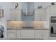 Well-lit kitchen featuring light grey cabinets and stainless steel appliances at 4878 Chitty Chatty Run, The Villages, FL 32163