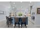 Kitchen with stylish pendant lights, island with seating, and view to landscaped outdoor area at 4878 Chitty Chatty Run, The Villages, FL 32163