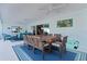Entertainer's lanai with dining, seating, and a view through sliding glass doors at 4878 Chitty Chatty Run, The Villages, FL 32163