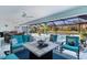 Inviting lanai with seating, a dining area, and a sparkling pool overlooking a serene waterfront view at 4878 Chitty Chatty Run, The Villages, FL 32163
