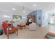 Bright living room with tile floors, ceiling fan, an entertainment center, and comfortable seating at 4878 Chitty Chatty Run, The Villages, FL 32163
