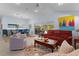 Open living room with a decorative rug, comfortable seating, and sliding glass doors to the outdoor area at 4878 Chitty Chatty Run, The Villages, FL 32163