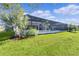 Spacious screened-in lanai overlooking the lush green lawn, perfect for relaxation and entertaining at 4878 Chitty Chatty Run, The Villages, FL 32163