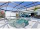Enclosed pool area with a spa, sun protection and outdoor seating at 4878 Chitty Chatty Run, The Villages, FL 32163