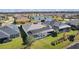 Aerial shot of the home's back exterior featuring a screened-in patio, backyard, and waterfront views at 4878 Chitty Chatty Run, The Villages, FL 32163