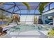 Inviting screened-in pool and spa area overlooking the tranquil pond at 4878 Chitty Chatty Run, The Villages, FL 32163