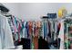 Spacious walk-in closet with ample storage and well-organized hanging racks at 4878 Chitty Chatty Run, The Villages, FL 32163