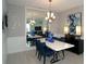 Bright dining room features a modern chandelier, sleek white table, and elegant decor at 5023 Firebush Dr, Apopka, FL 32712
