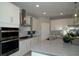 Modern kitchen with white cabinetry, stainless steel appliances, a stylish backsplash, and a spacious island at 5023 Firebush Dr, Apopka, FL 32712