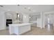 Modern kitchen featuring a spacious island, stainless steel appliances, and elegant gray cabinetry at 5023 Firebush Dr, Apopka, FL 32712