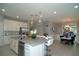 Open concept kitchen and dining area with an island, modern appliances, and stylish decor at 5023 Firebush Dr, Apopka, FL 32712
