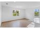 Dining area with wood-look tile floors, contemporary chandelier, and a view of the backyard at 5107 Marshelder St, Apopka, FL 32712