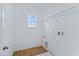 Laundry room with a window, wooden floors and storage rack at 5107 Marshelder St, Apopka, FL 32712