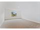 Bright living room with neutral carpet and natural light from the window at 5107 Marshelder St, Apopka, FL 32712