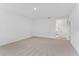 Neutral colored living room with carpeted floors and an open doorway at 5107 Marshelder St, Apopka, FL 32712