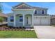 Charming two-story home with a two-car garage and a beautifully landscaped front yard at 5155 Nickerbean St, Apopka, FL 32712