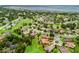 High angle aerial perspective of a community homesite with a screened-in pool and terracotta roof at 5235 Island Terrace Ct, Lady Lake, FL 32159