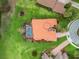 Overhead shot displaying a terracotta-roofed home featuring a screened-in pool and lush landscaping at 5235 Island Terrace Ct, Lady Lake, FL 32159