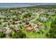 Aerial view of a home with a screened pool and a terracotta roof within a residential community at 5235 Island Terrace Ct, Lady Lake, FL 32159