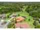 Aerial shot of a home featuring a screened-in pool, terracotta roof, and mature landscaping at 5235 Island Terrace Ct, Lady Lake, FL 32159
