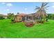 Lush backyard features a screened-in pool area with landscaping at 5235 Island Terrace Ct, Lady Lake, FL 32159