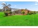 Expansive backyard with a screened-in pool area and lush landscaping at 5235 Island Terrace Ct, Lady Lake, FL 32159