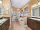 Bathroom featuring double sinks, a walk-in shower, and a large soaking tub at 5235 Island Terrace Ct, Lady Lake, FL 32159