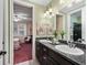 Bathroom featuring a double vanity and view into the adjacent bedroom at 5235 Island Terrace Ct, Lady Lake, FL 32159